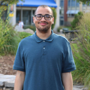 This photo shows Demitric Baez, the owner of BaEZelevates, in a professional headshot.